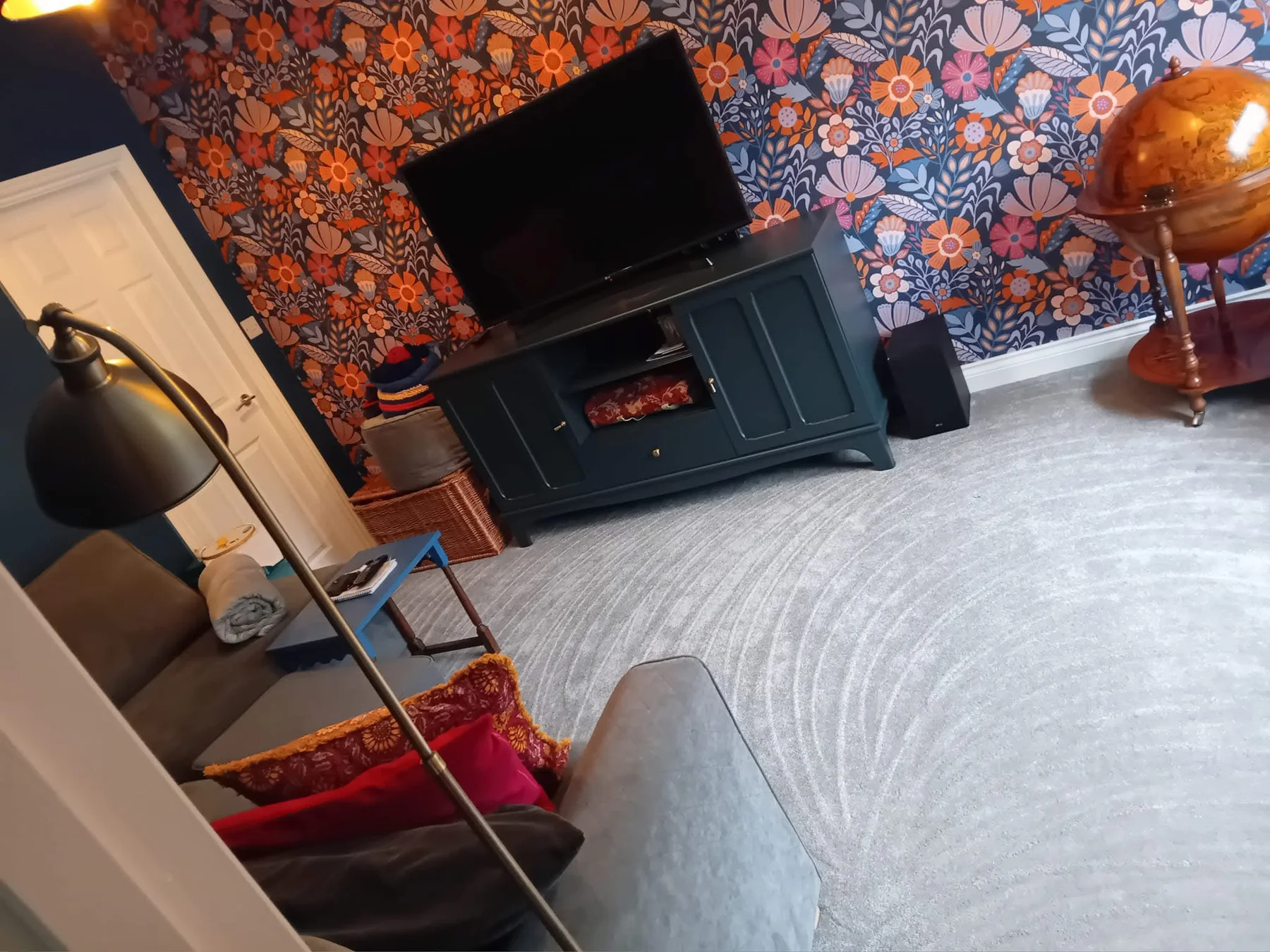 Living room with patterned wallpaper and freshly vacuumed carpet
