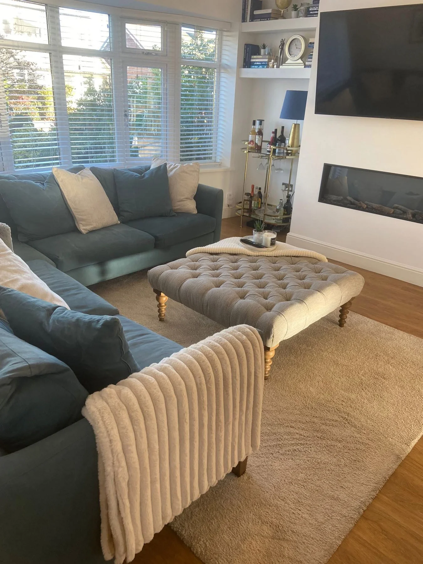 Tidy lounge with cushions, ottoman and vacuumed carpet