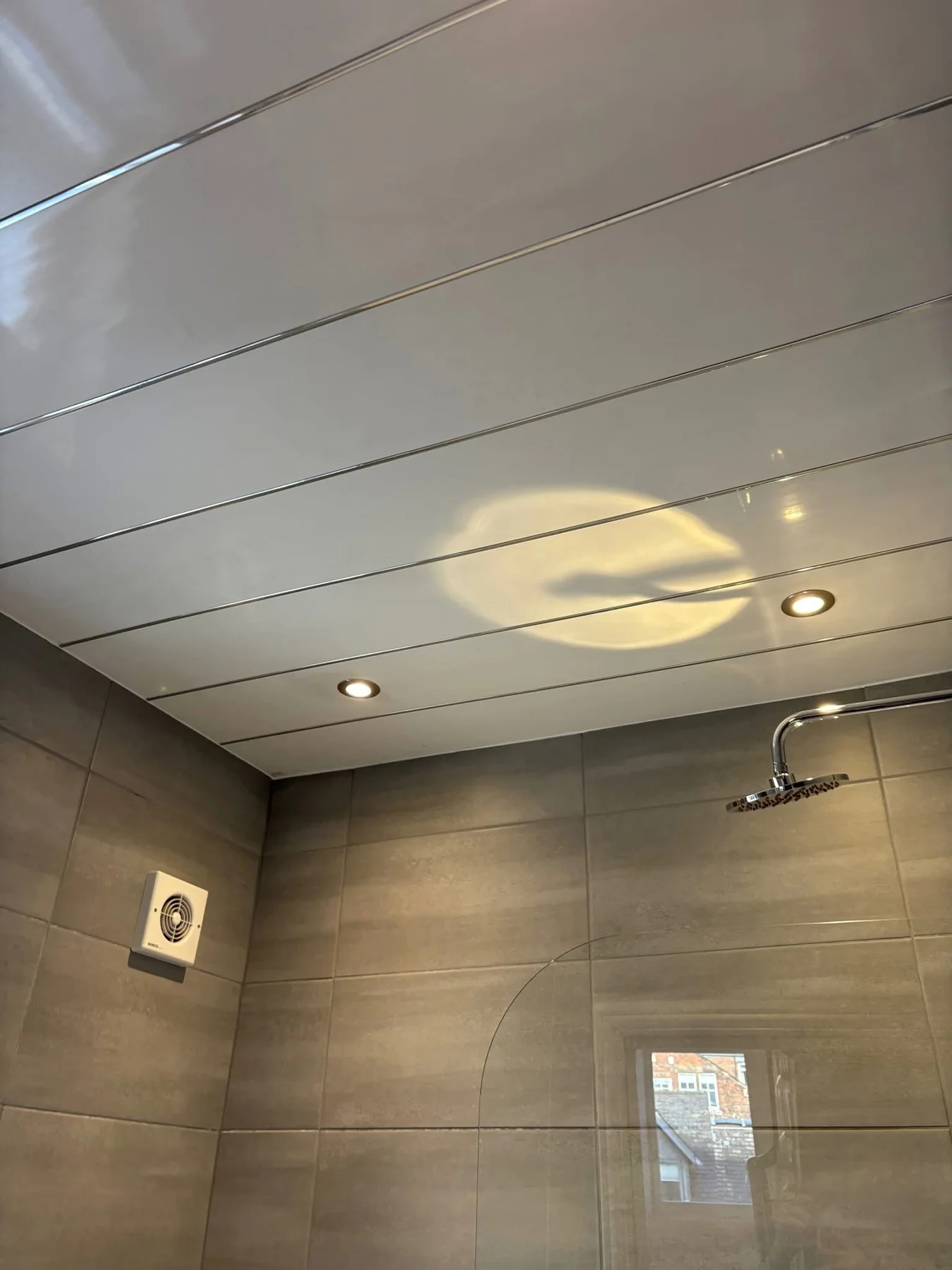 Shower glass and tiled bathroom walls